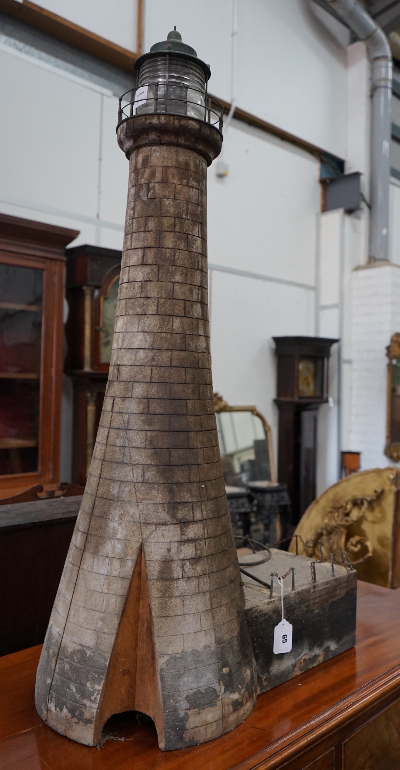 A vintage brick effect wood model lighthouse, wired for electricity height 110cm